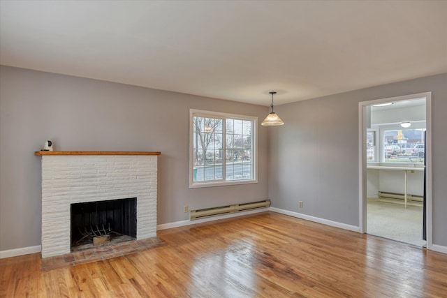 403 W Chestnut St, Almira, WA 99103 - unfurnished living room with baseboard heating, wood finished floors, healthy amount of natural light, and baseboards