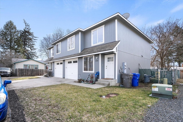 traditional-style home with roof with shingles, concrete driveway, fence, an attached garage, and a front yard