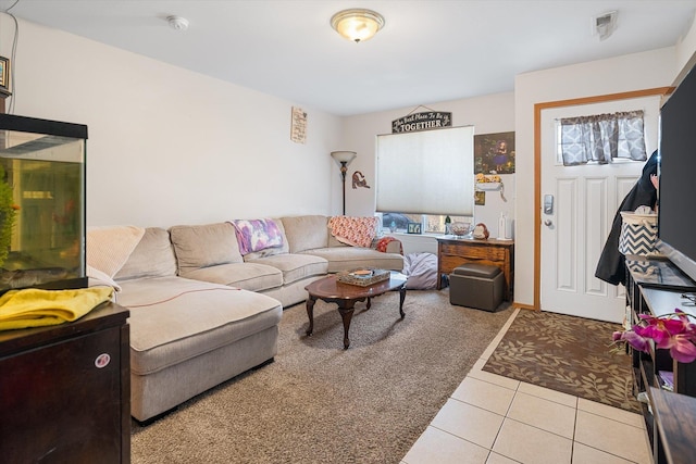 living area with carpet floors and tile patterned flooring