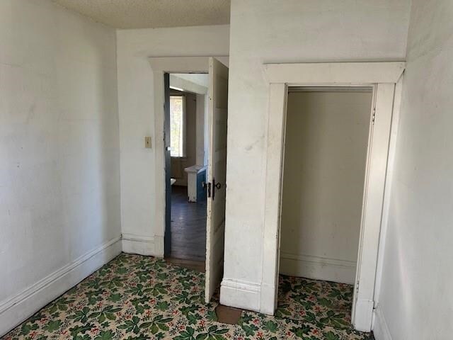 unfurnished bedroom with baseboards