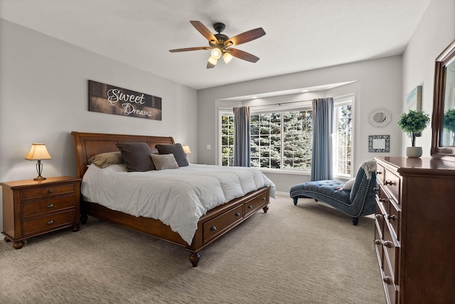 carpeted bedroom featuring ceiling fan and multiple windows