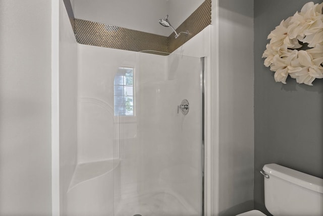 full bath with a shower stall and toilet