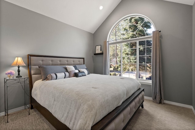 bedroom with high vaulted ceiling, carpet flooring, baseboards, and multiple windows