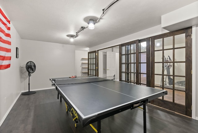 recreation room with wood finished floors, baseboards, and french doors