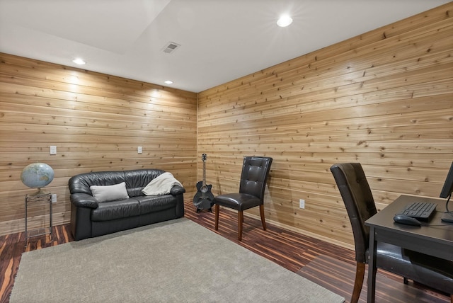 office featuring wooden walls, visible vents, and recessed lighting