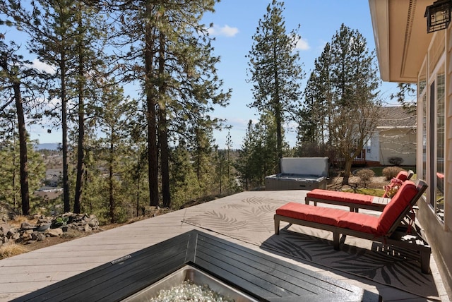 wooden deck with a covered hot tub