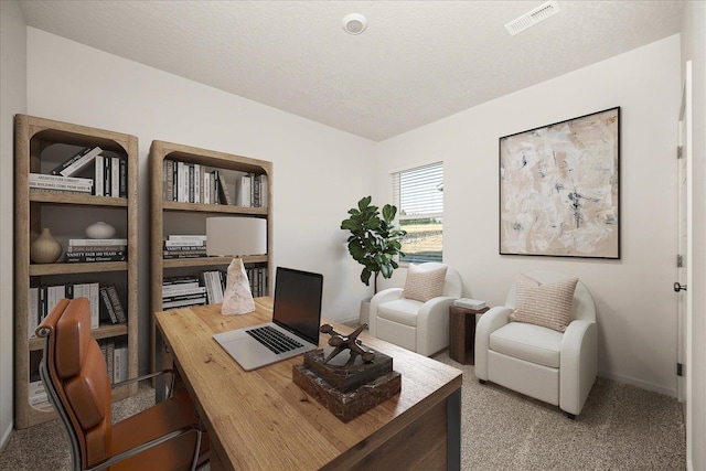 carpeted office space featuring baseboards and visible vents