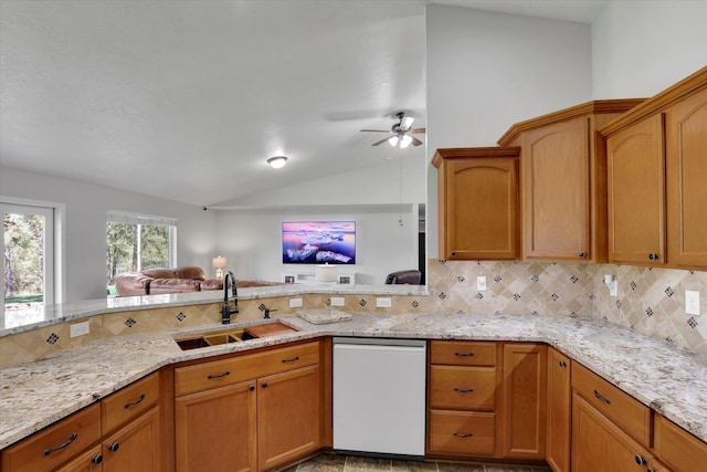 5818 S Abbott Rd, Spokane, WA 99224 - kitchen featuring white dishwasher, a sink, backsplash, vaulted ceiling, and light stone counters