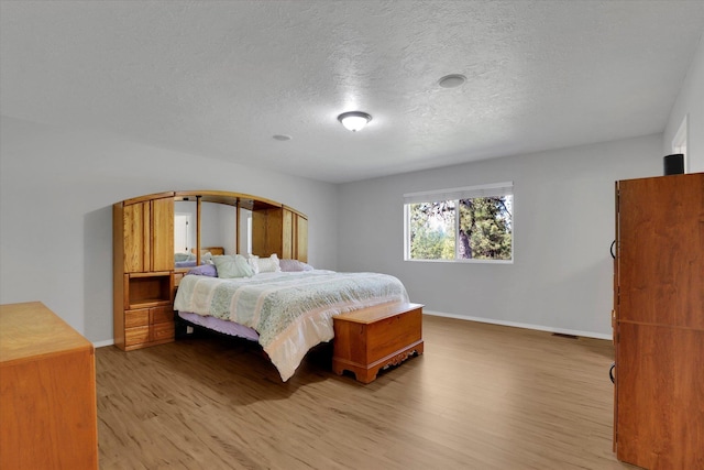 5818 S Abbott Rd, Spokane, WA 99224 - bedroom featuring light wood-type flooring, baseboards, and a textured ceiling