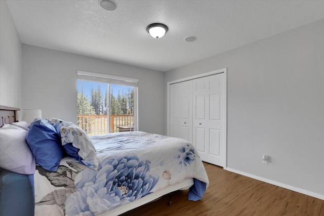 5818 S Abbott Rd, Spokane, WA 99224 - bedroom featuring wood finished floors, baseboards, a closet, and a textured ceiling