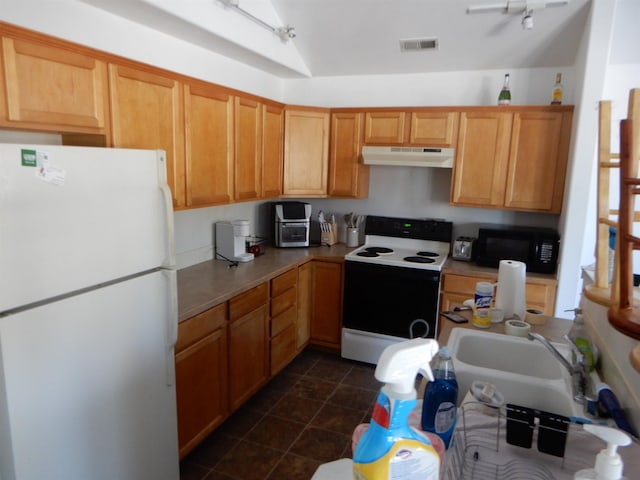 kitchen featuring range with electric cooktop, under cabinet range hood, visible vents, freestanding refrigerator, and black microwave