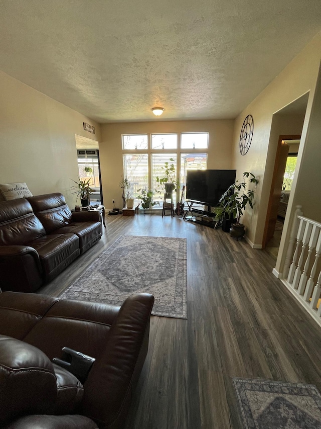 living area featuring a textured ceiling, wood finished floors, and a wealth of natural light