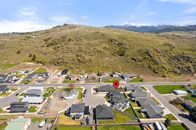 drone / aerial view featuring a residential view and a mountain view