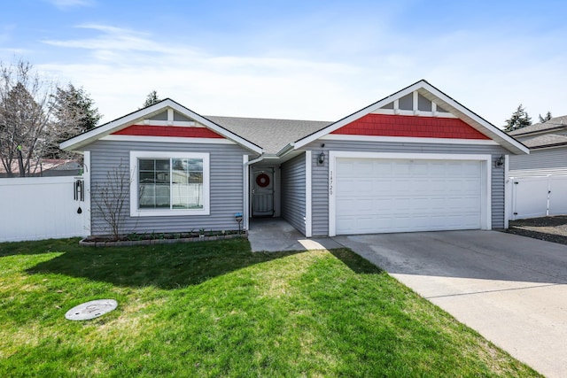 view of front of house featuring an attached garage, fence, a front yard, and concrete driveway