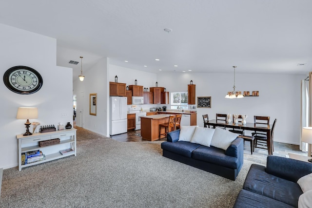 living room with lofted ceiling, dark carpet, visible vents, baseboards, and a notable chandelier