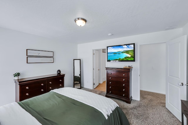 bedroom featuring baseboards and carpet