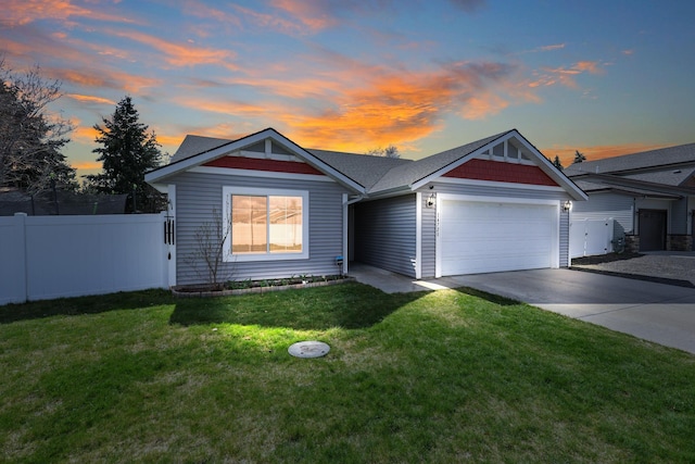 ranch-style home with an attached garage, concrete driveway, fence, and a lawn