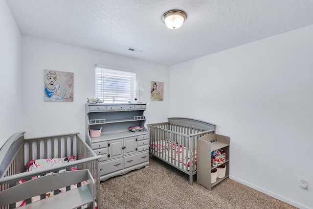 bedroom featuring baseboards, visible vents, carpet floors, and a nursery area