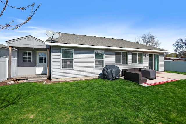 rear view of house featuring a lawn, a patio, fence, and an outdoor living space