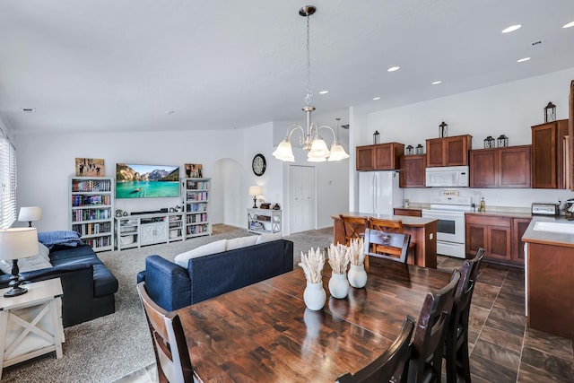 dining space featuring recessed lighting and a notable chandelier