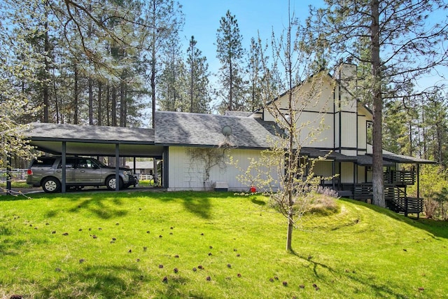 21203 W Beechwood Rd, Medical Lake, WA 99022 - view of side of home with a lawn, a chimney, and an attached carport