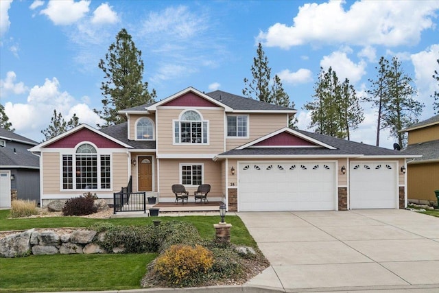 28 E Lindsey Ln, Spokane, WA 99208 - traditional-style home with driveway, an attached garage, a front yard, a shingled roof, and stone siding