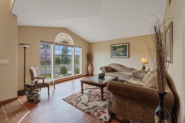 28 E Lindsey Ln, Spokane, WA 99208 - living area with lofted ceiling, wood finished floors, and baseboards