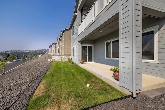 exterior space with a yard, a residential view, and a patio area