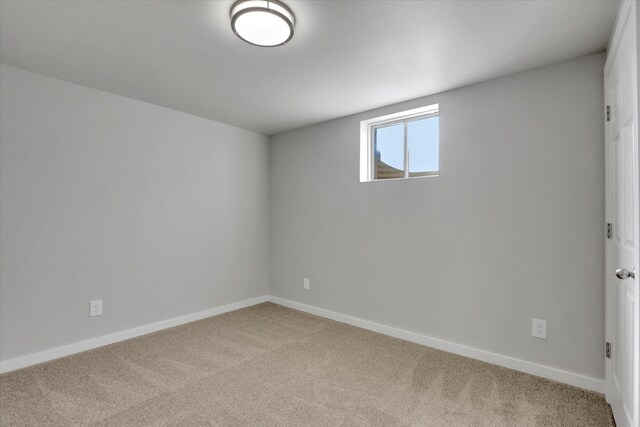 carpeted spare room with baseboards