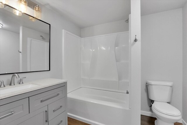 full bath with toilet, vanity, and  shower combination