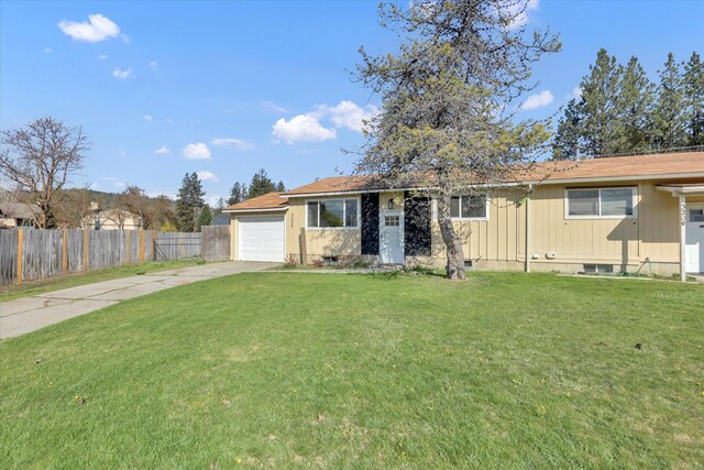 ranch-style home with fence, an attached garage, a front yard, and concrete driveway