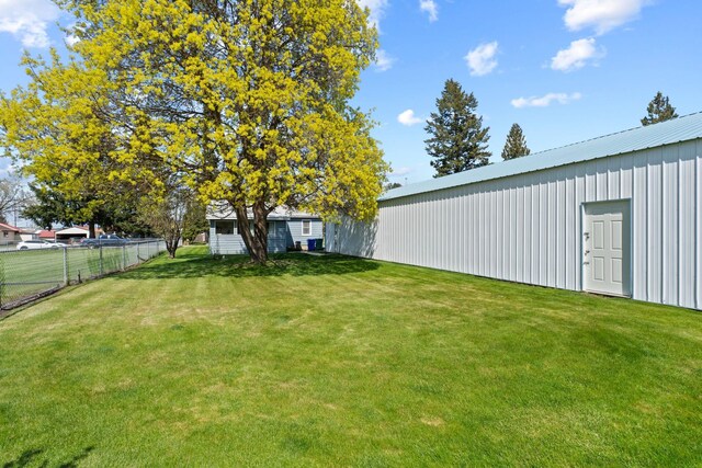 view of yard with an outbuilding and fence