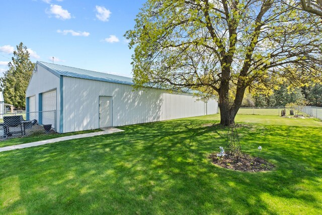 view of pole building featuring a yard and fence