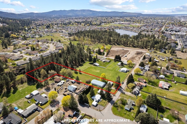 drone / aerial view featuring a residential view and a water and mountain view