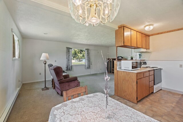 kitchen featuring open floor plan, an inviting chandelier, baseboard heating, white appliances, and under cabinet range hood