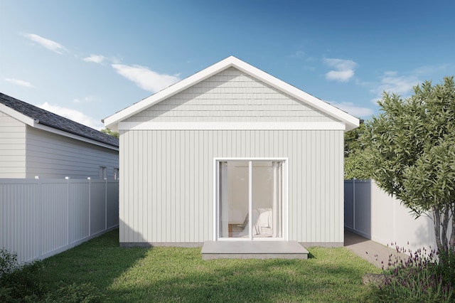 exterior space with a lawn, fence, and an outbuilding