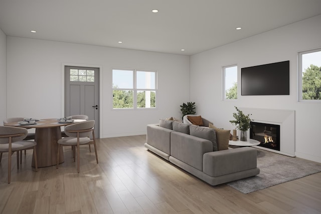 living area with recessed lighting, plenty of natural light, and light wood-style flooring