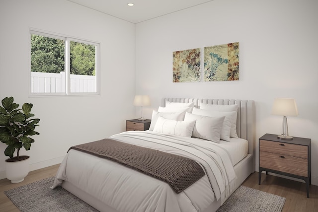 bedroom with wood finished floors and recessed lighting