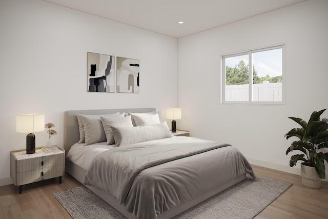 bedroom with baseboards and light wood finished floors