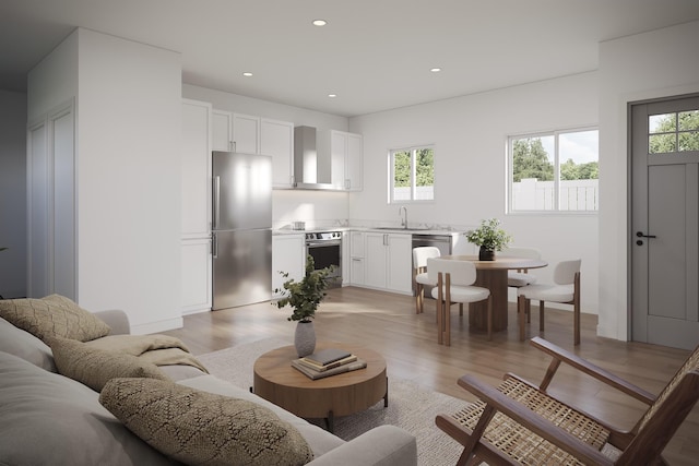living area with light wood finished floors, recessed lighting, and a healthy amount of sunlight