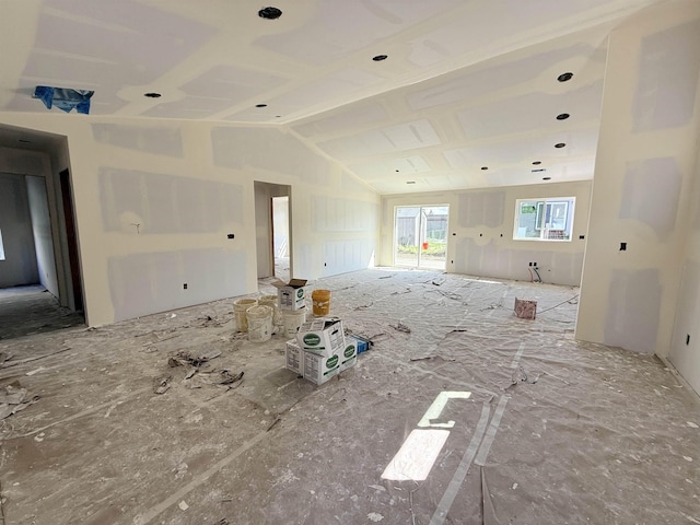 unfurnished room featuring lofted ceiling
