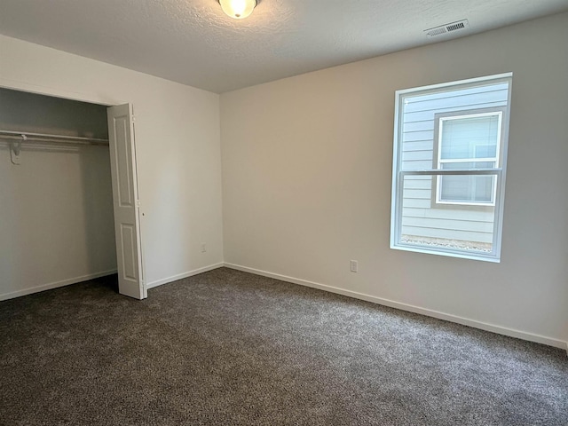 9520 E Michielli Ln, Spokane Valley, WA 99206 - unfurnished bedroom with dark carpet, multiple windows, and a closet