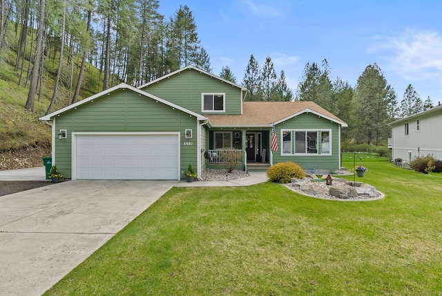 5981 Blackstone Way, Nine Mile Falls, WA 99026 - view of front of home with covered porch, an attached garage, driveway, a front lawn, and roof with shingles