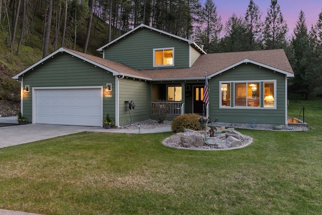 5981 Blackstone Way, Nine Mile Falls, WA 99026 - view of front facade featuring covered porch, driveway, roof with shingles, a garage, and a front yard