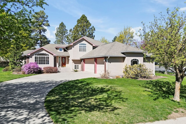view of front of house with a front lawn, driveway, roof with shingles, and a garage
