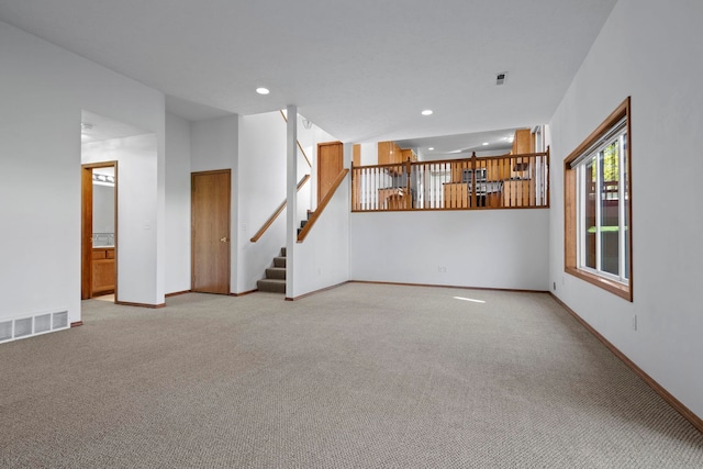 4604 E Birkdale Ln, Spokane, WA 99223 - unfurnished living room with light carpet, stairway, and recessed lighting