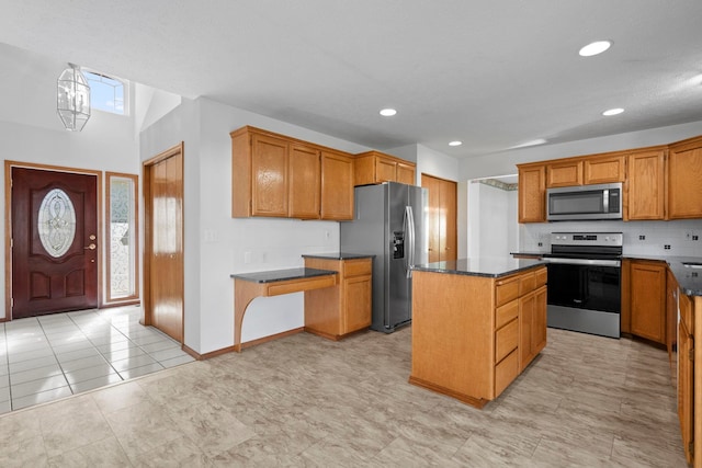 kitchen featuring stainless steel appliances, dark countertops, decorative backsplash, brown cabinetry, and a kitchen island
