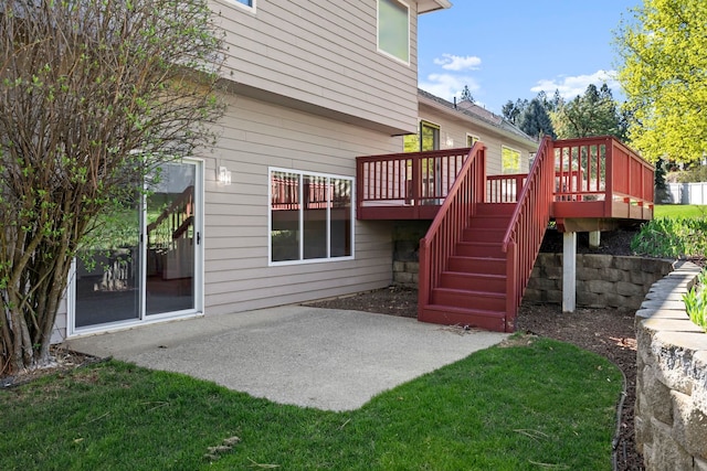 back of property with a yard, stairway, a deck, and a patio