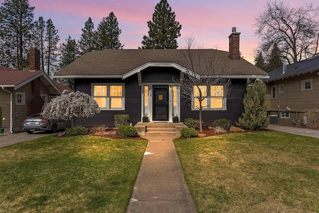 808 W 25th Ave, Spokane, WA 99203 - view of front of house featuring a lawn, a chimney, and a shingled roof