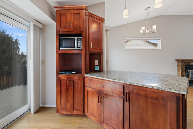 9701 W Masters Ln, Cheney, WA 99004 - kitchen featuring stainless steel microwave, light wood finished floors, light stone countertops, a chandelier, and lofted ceiling